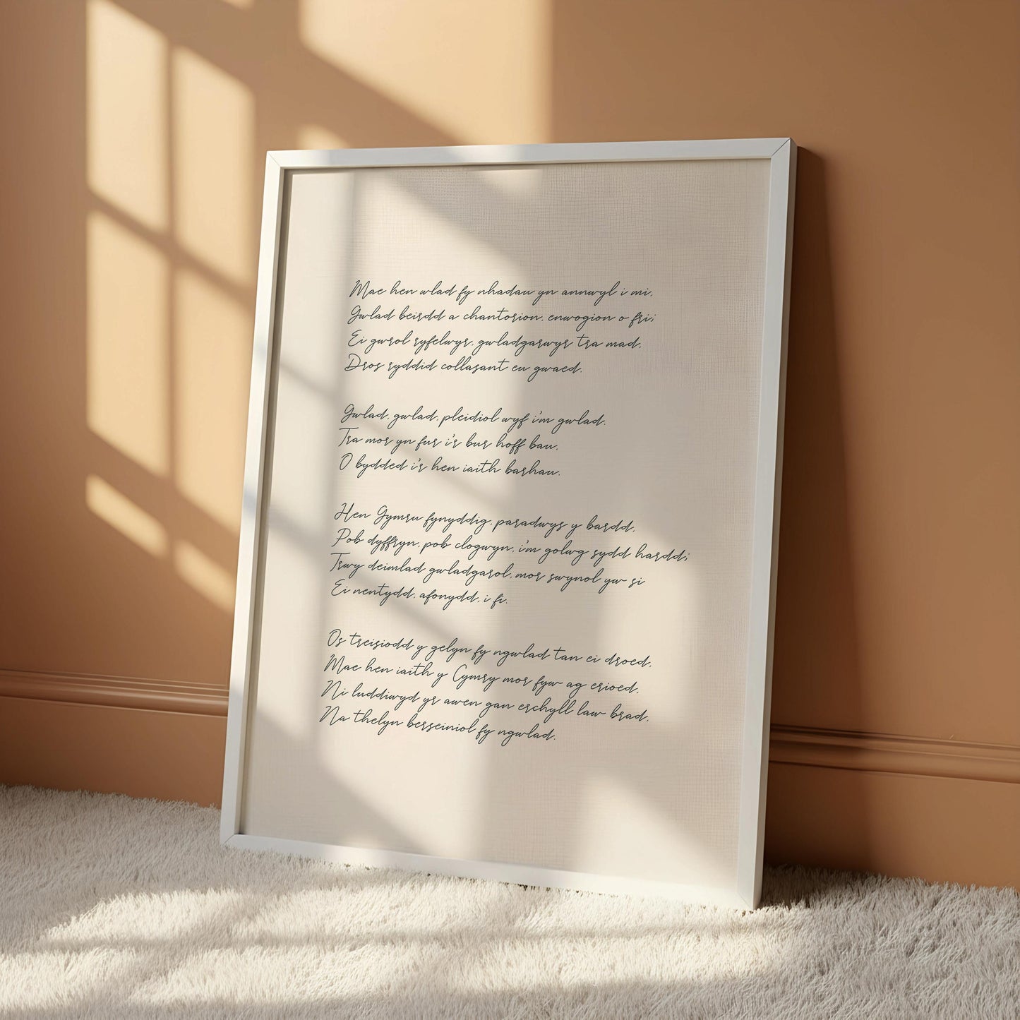 a white framed poster with handwritten text, hanging on a wall.