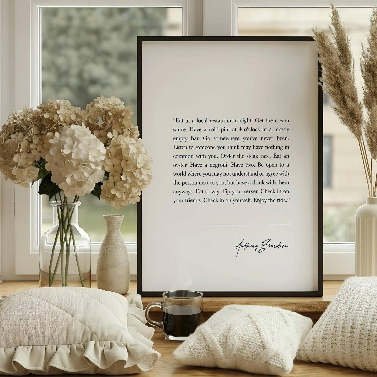 a wooden chair with a book resting on it, positioned next to a framed quote on a wall.