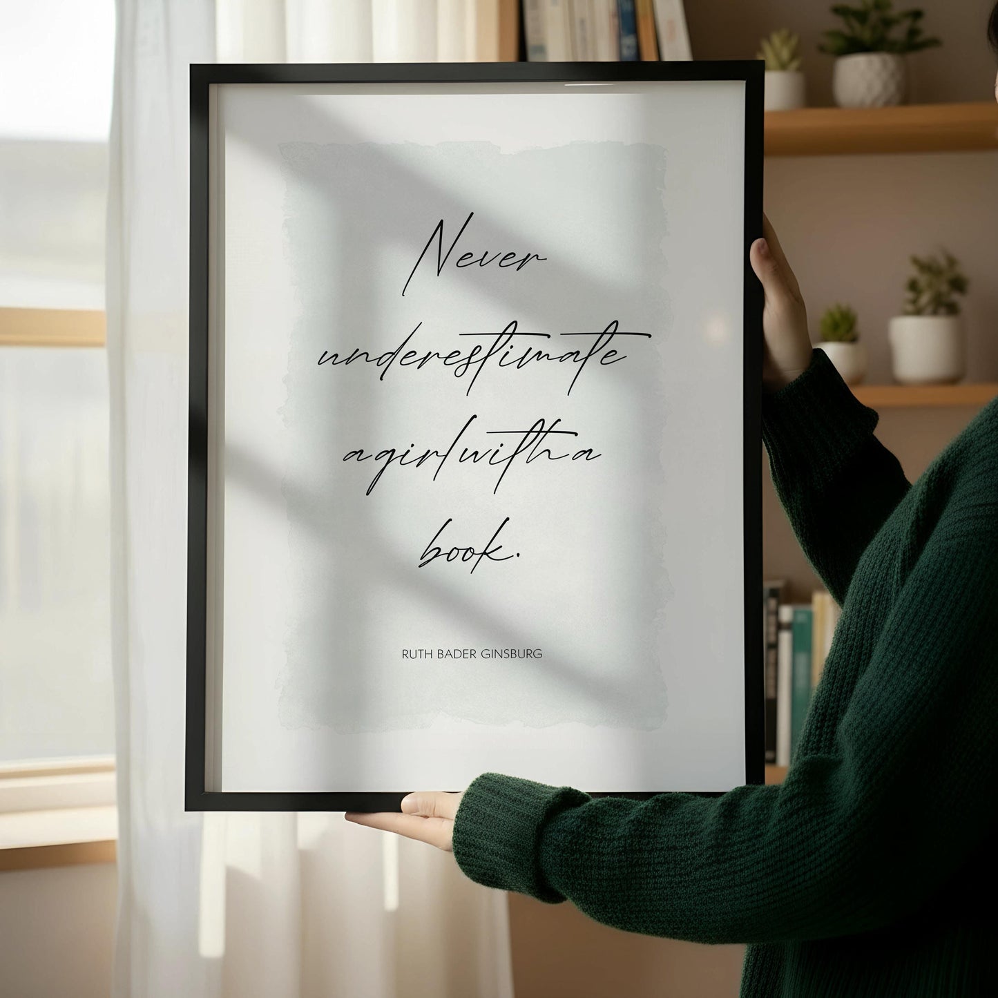 a framed quote by Ruth Bader Ginsburg that reads "Never underestimate again with a book".