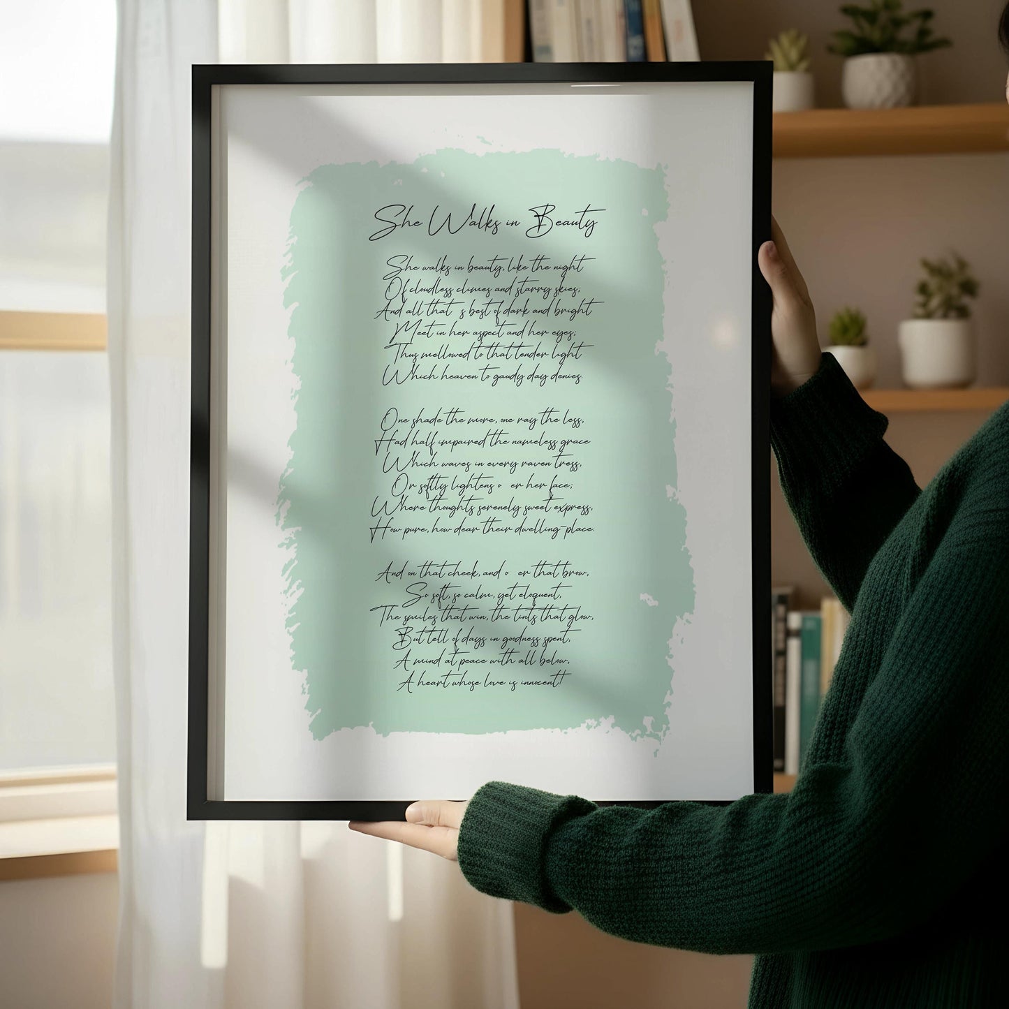 a framed print of a poem leaning against a wall, with a wooden chair and a stack of books placed next to it on a wooden floor.