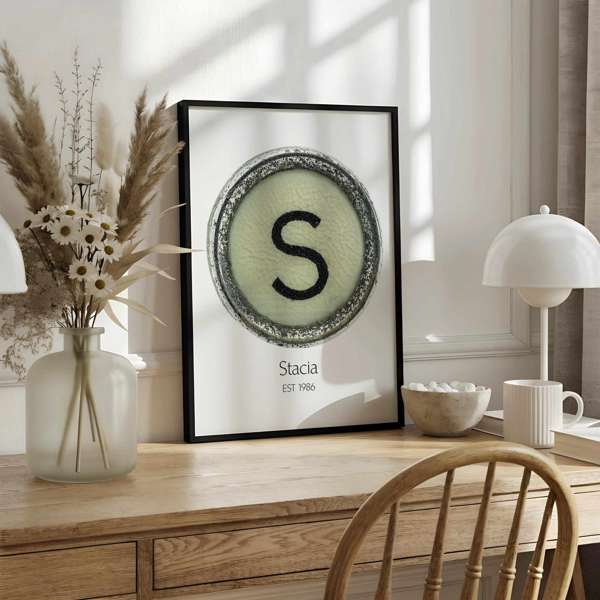 a poster with a circular design containing the letter 'S' and the text "Stacia EST 1986" below it.