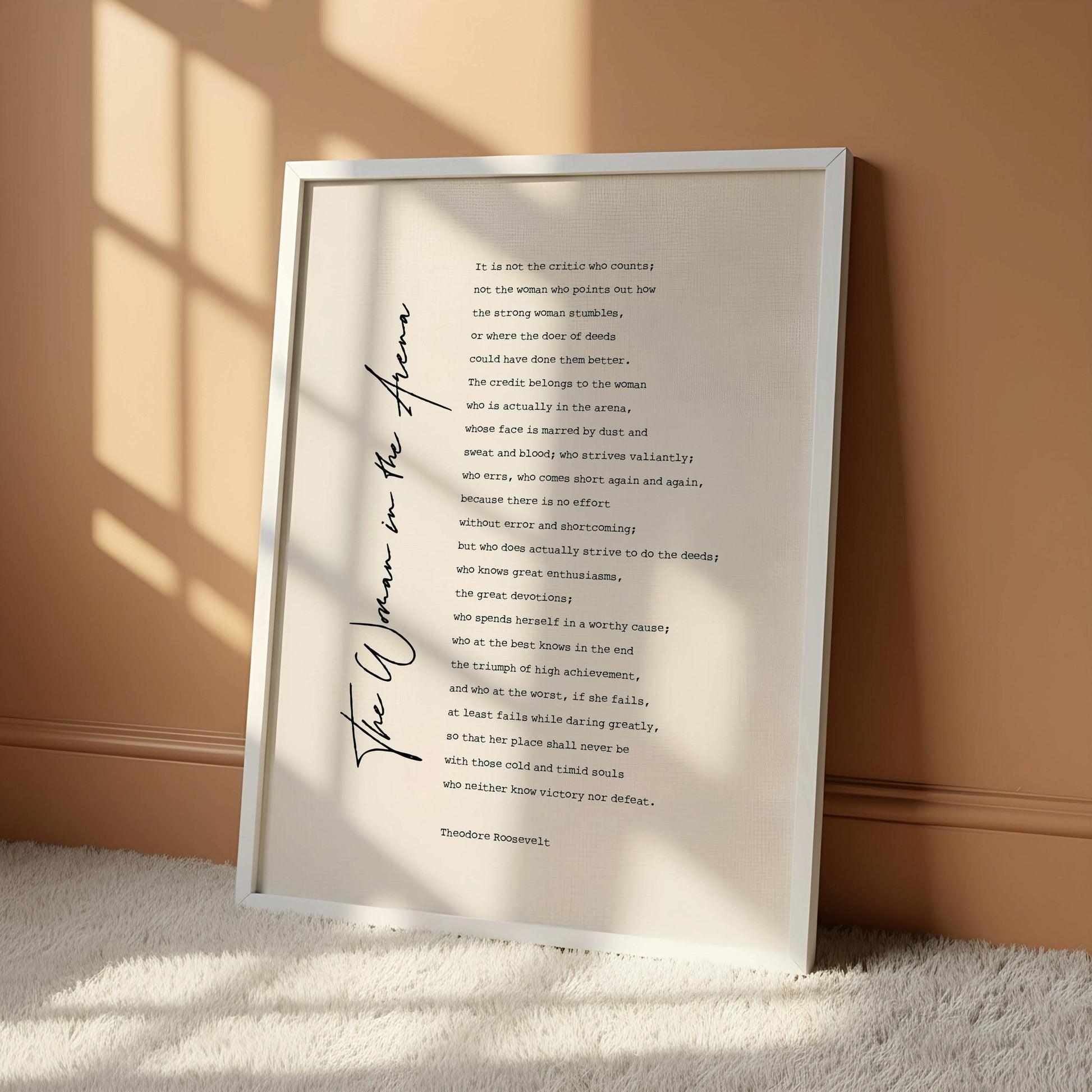 a framed text that reads "The woman in the arena" by Theodore Rosseff.