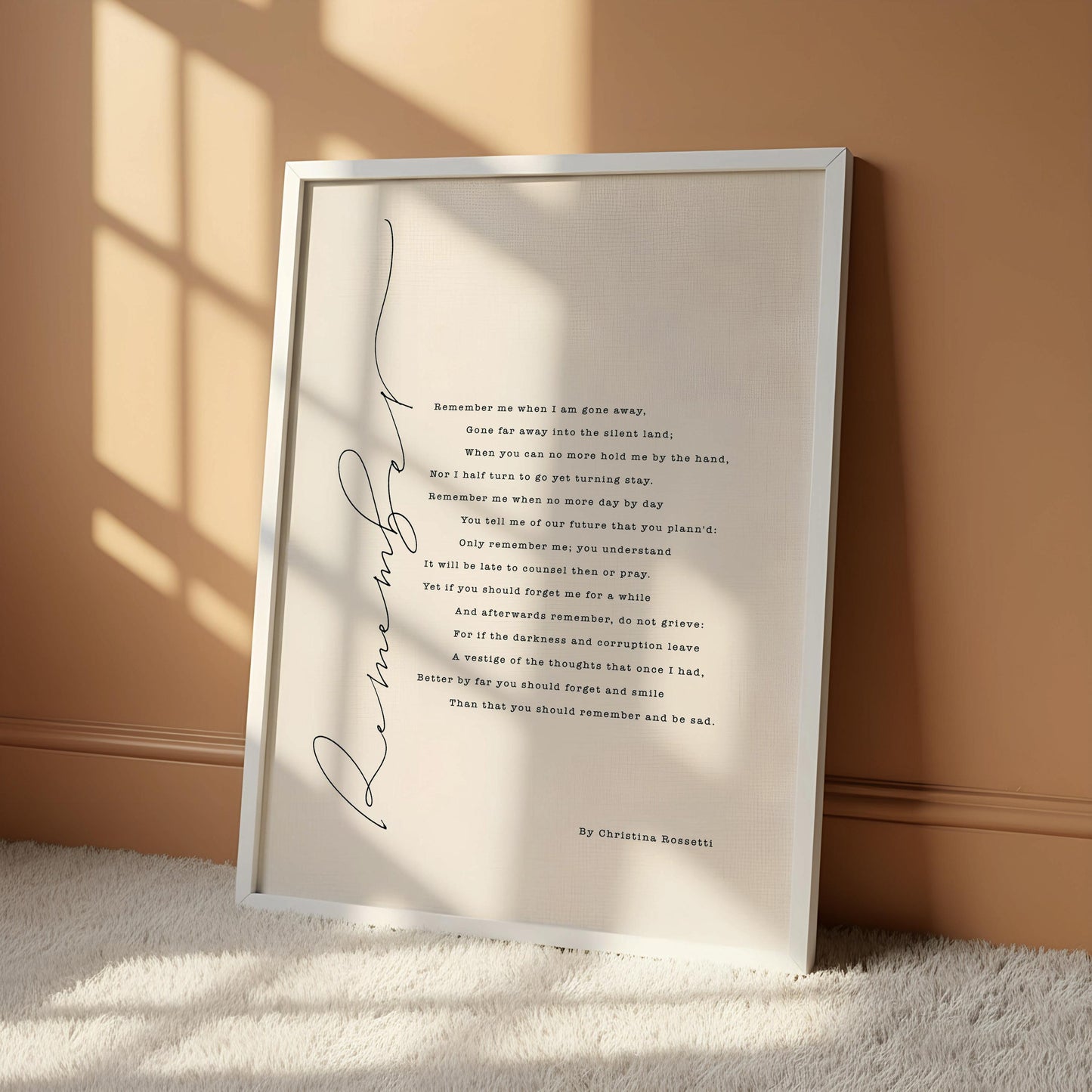 a framed poem titled "Remember" by Christina Rossetti, hanging on a wall.