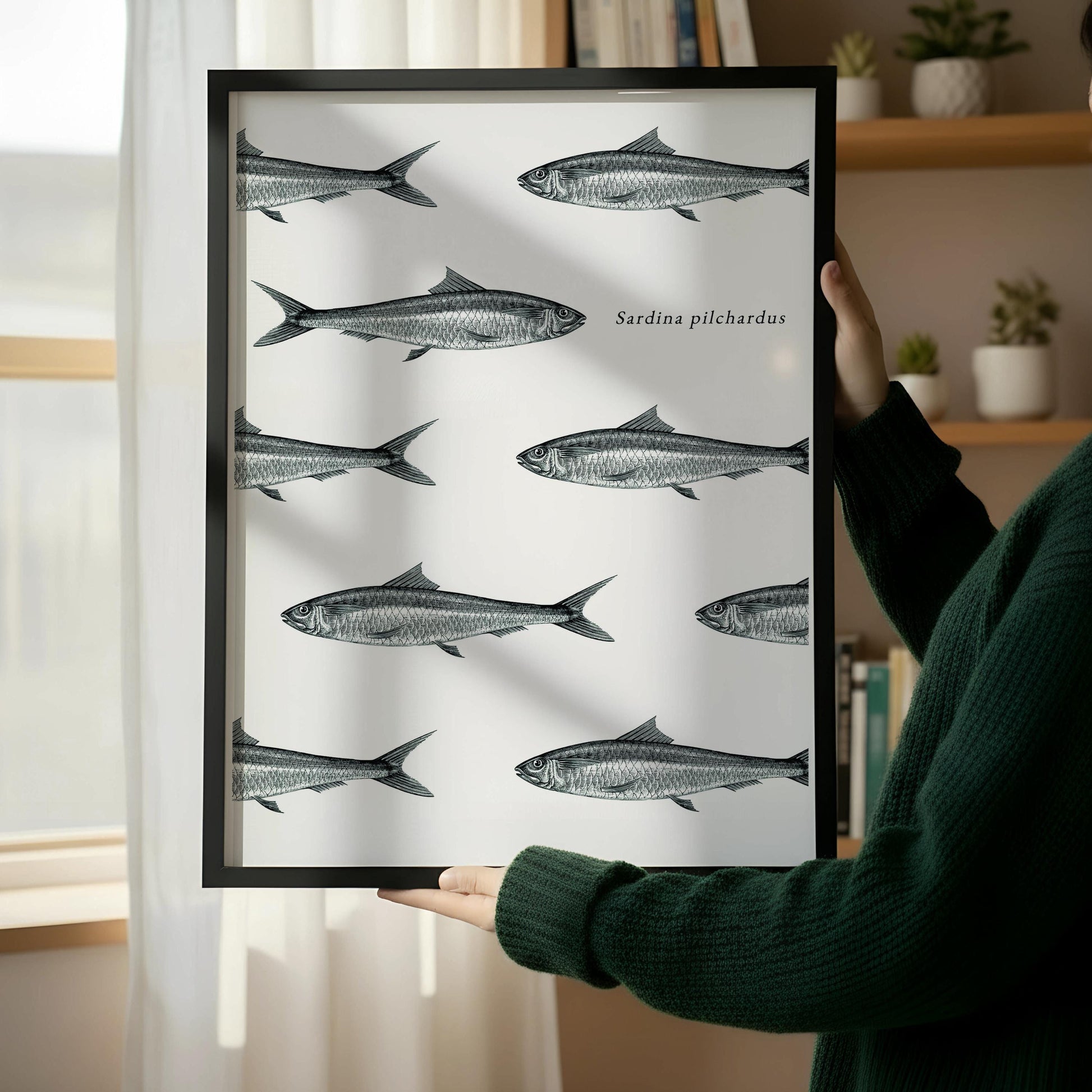 a framed print of fish on a wall, with a wooden chair and a stack of books placed next to it.