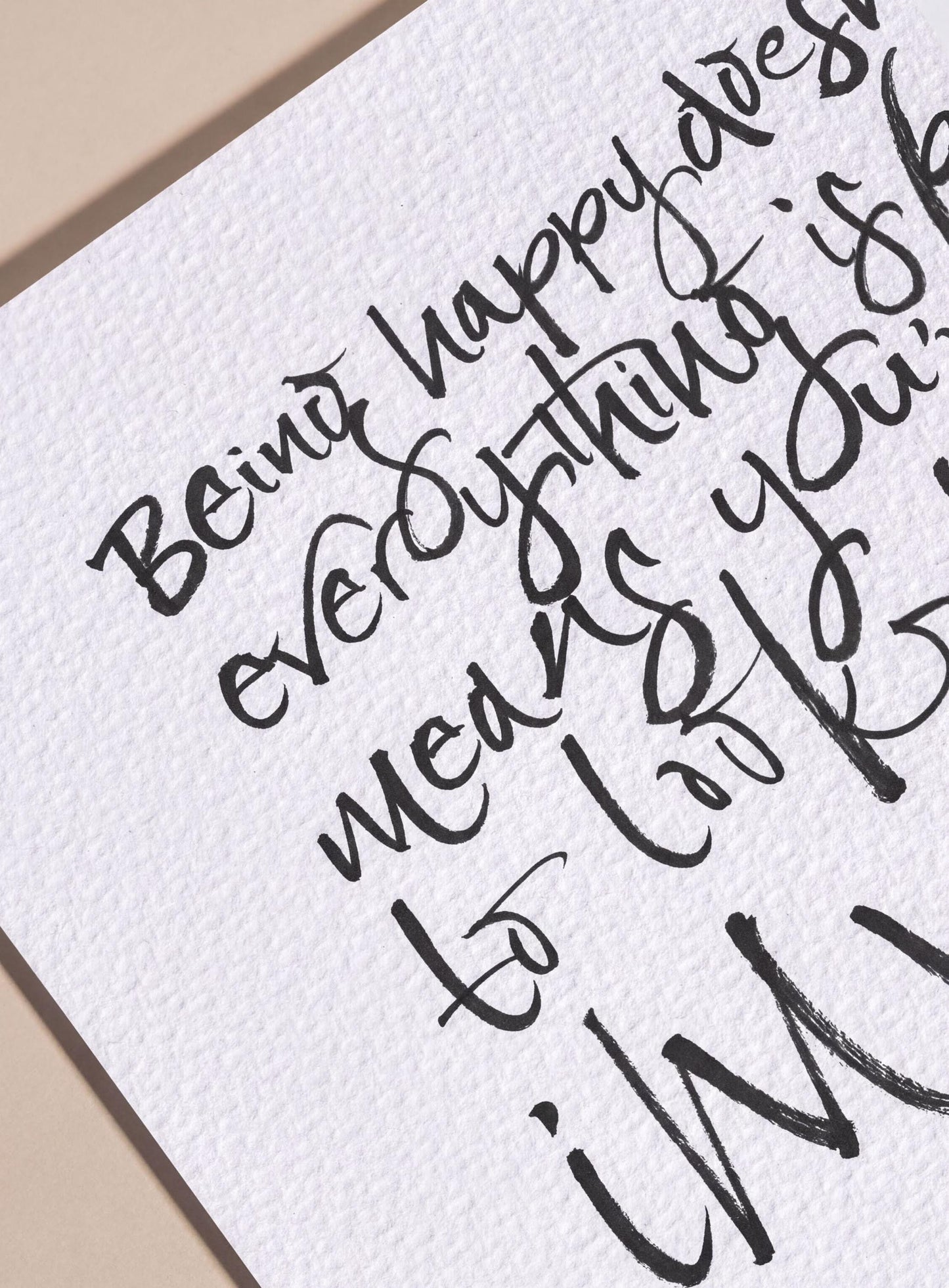 a handwritten message that reads "Being happy means everything is worth living".