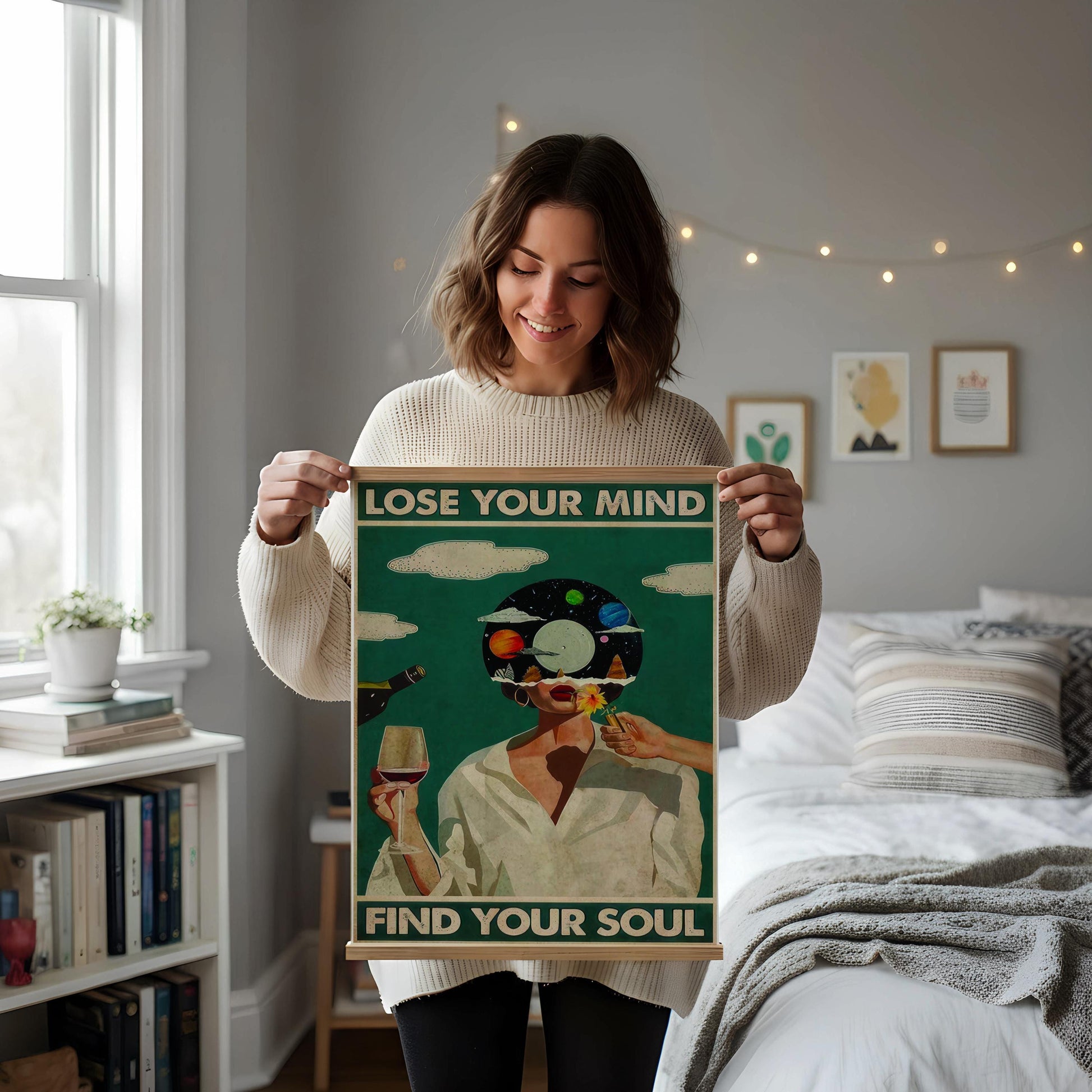 a framed poster with the text "LOSE YOUR MIND FIND YOUR SOUL" displayed on a white wall above a desk with various items on it, including a notebook, a cup, and a vase.